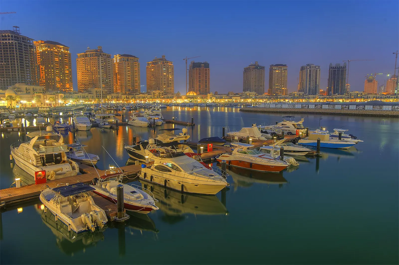 Boats docked at a marina at dusk — the hours when most boat theft and vandalism happens