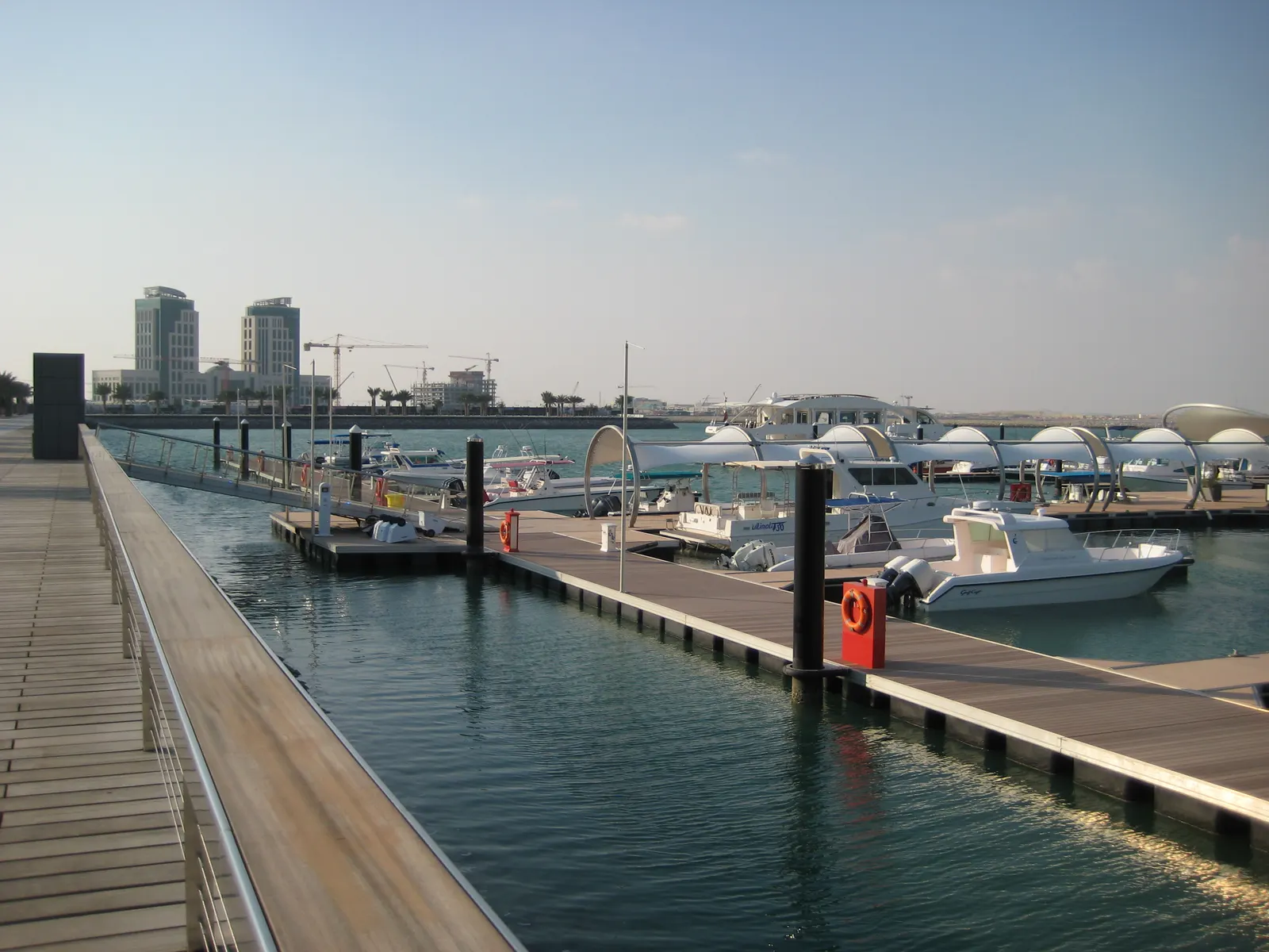 Marina dock with moored boats — visible cameras change which slips thieves target